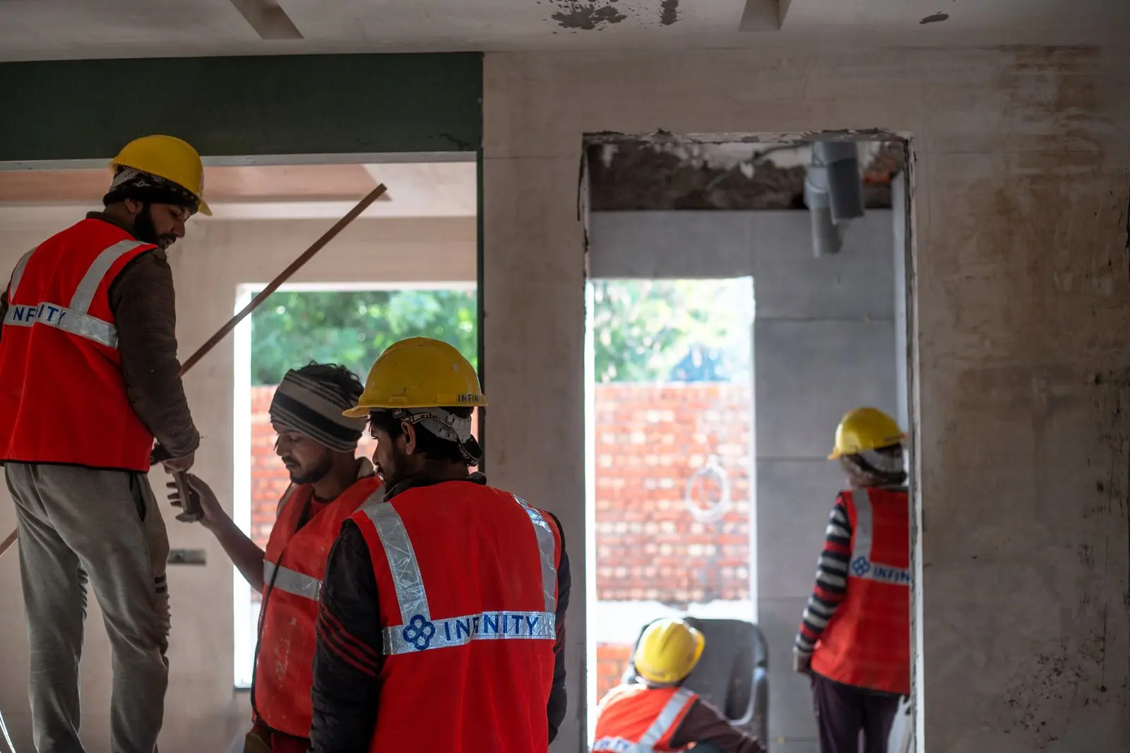 Construction team in safety gear at a building site — representative turnkey execution reference