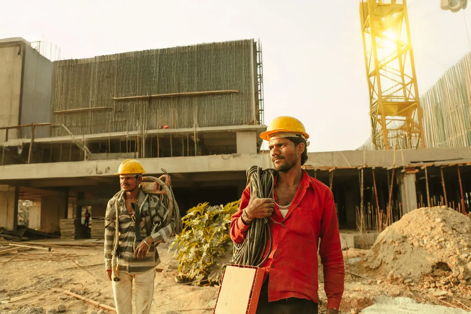 Construction workers and tower crane at an Indian building site — representative construction-stage reference