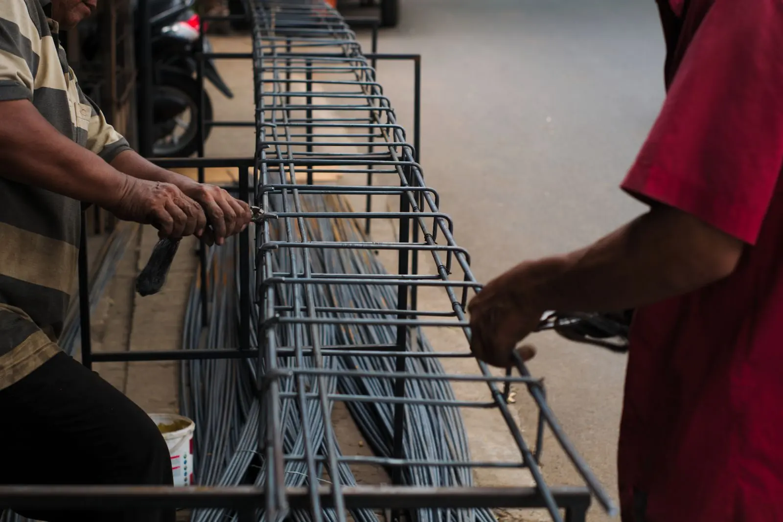 Workers assembling steel rebar during RCC work — representative construction-stage reference